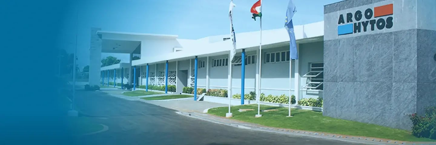 ARGO-HYTOS production facility with company logo on the entrance building and flagpoles in front.